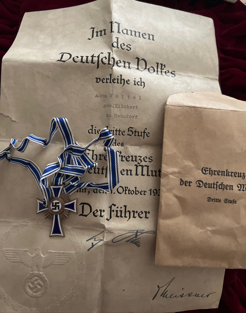 Nazi Germany, Mother’s Cross, 3rd Class in bronze, with full neck ribbon, original packet of issue and award citation to Anna Voitel