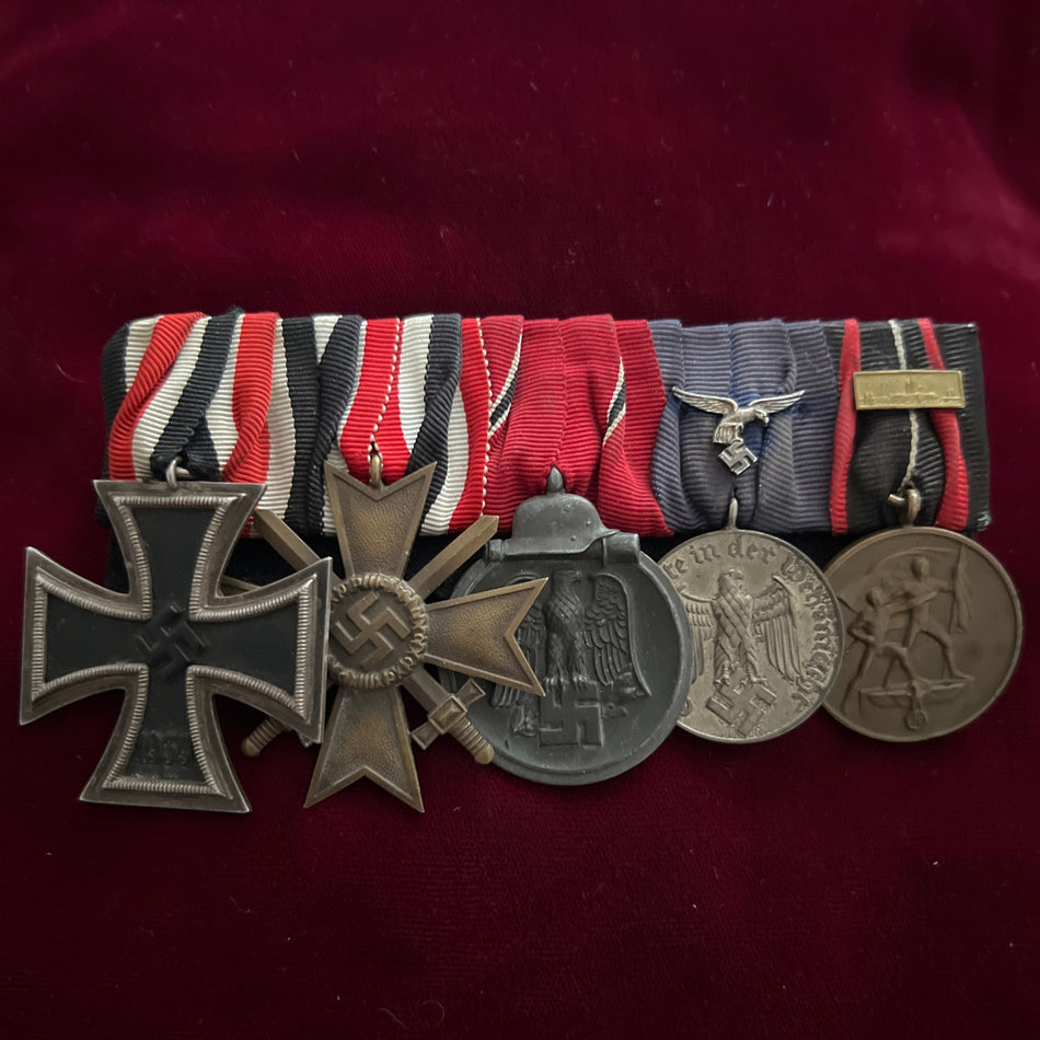 Nazi Germany, group of five: Iron Cross, War Merit Cross, Russian Front Medal, 4-Year Long Service Medal with Luftwaffe emblem, and Entry into Czechoslovakia Medal with small Prague bar, some wear