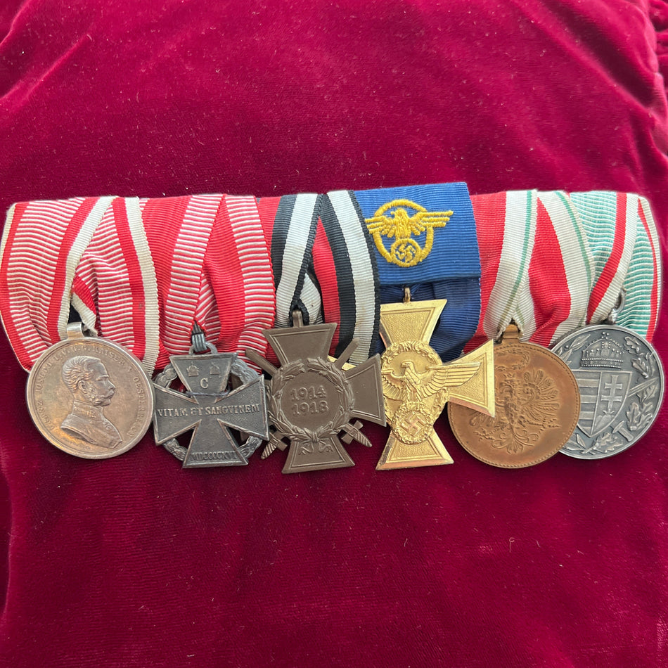 Austro-Hungarian/ German group of six: Franz Joseph small silver bravery medal, Karl Troop Cross, Cross of Honour 1914-18, Nazi Police 25-Year Long Service Cross, Tyrol Defence Medal and Hungarian War Commemorative Medal, an interesting group