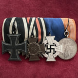 Imperial Germany/ Nazi Germany group of 4: WW1 Iron Cross, Cross of Honour with swords 1914-18, 25 Years Faithful Service Cross & Olympic Medal 1936