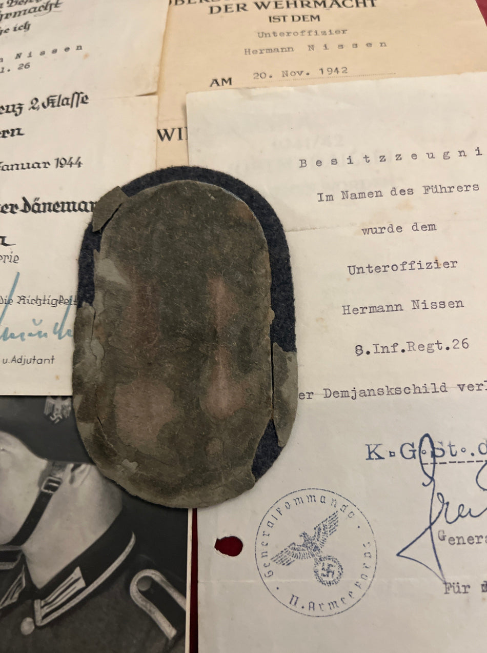 Nazi Germany, Demjansk Arm Shield with original award document (31/12/1943) and award documents for Russian Front Medal (20/11/1942) & War Merit Cross (30/1/1944), awarded to Unteroffizier Herman Nissan, 4 Reserve Fusiliers, Battalion 26, a scarce lot