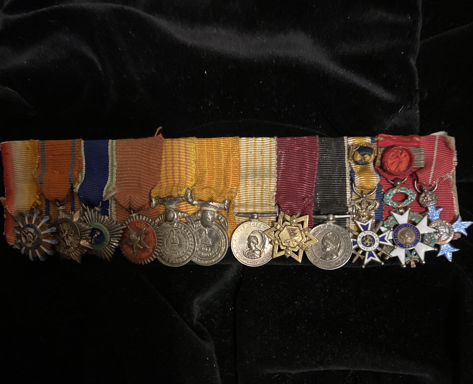 An interesting group of 12 miniature medals: 9 Gurkha medals, Dutch Order of Orange-Nassau, French Legion of Honour & Commander of the British Empire